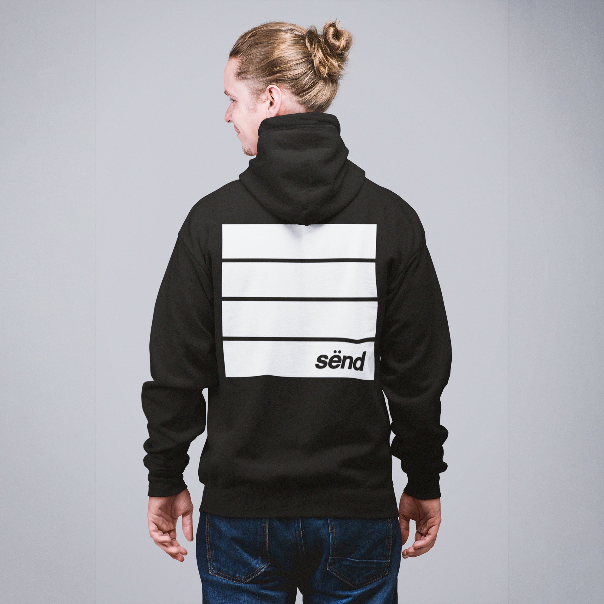 A blond motocross rider wearing a black zip-hoodie jacket with a large graphic backprint