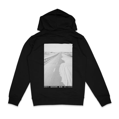 Backside of a black hoodie with a large photo backprint of a desert road 