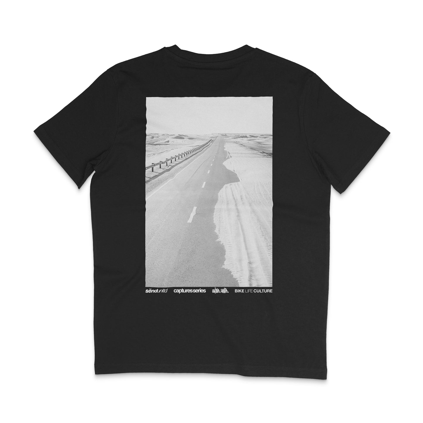 Backside of a black t-shirt with a large photo backprint of a desert road 