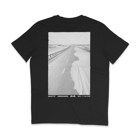 Backside of a black t-shirt with a large photo backprint of a desert road 